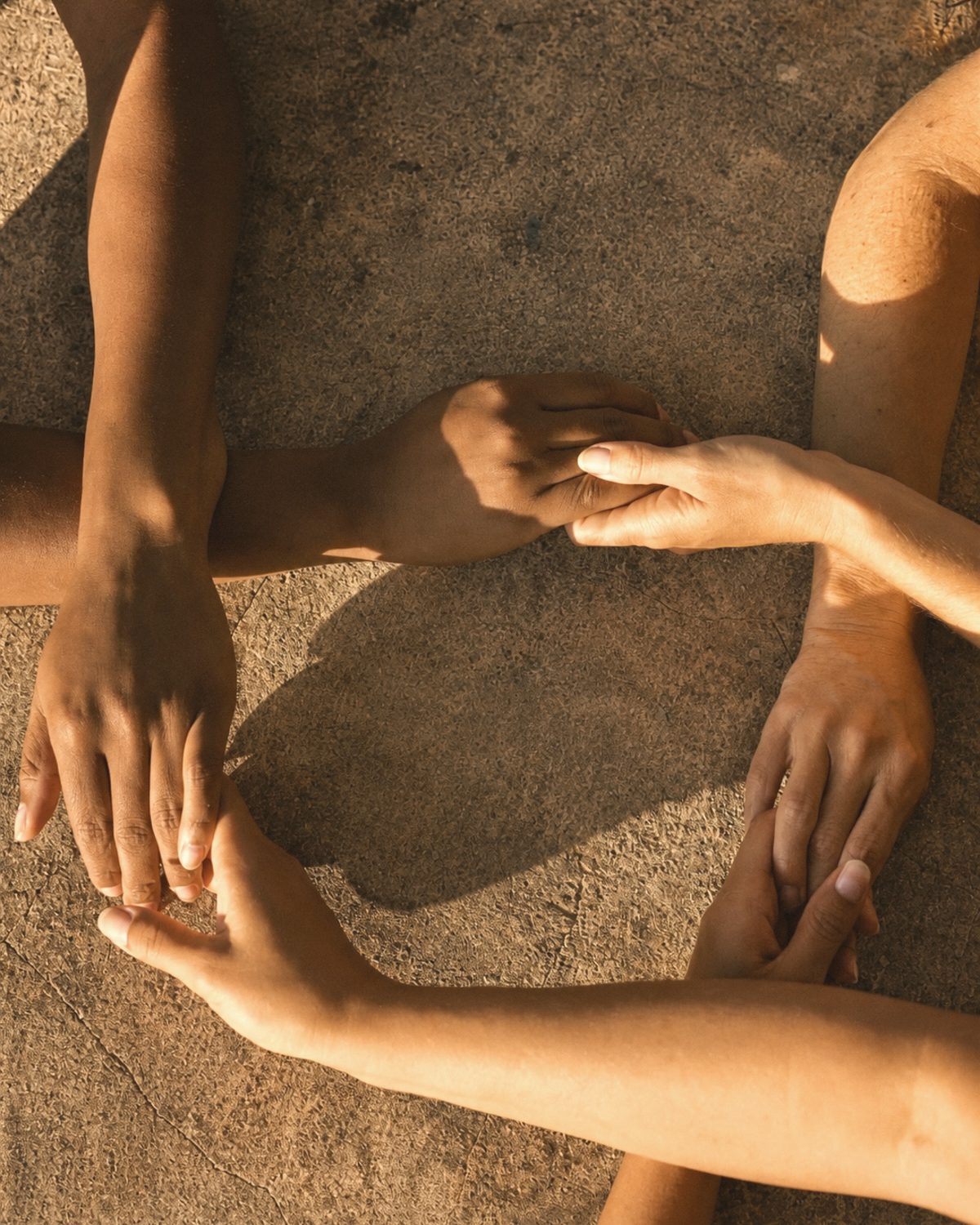 Hands, held together in warm light